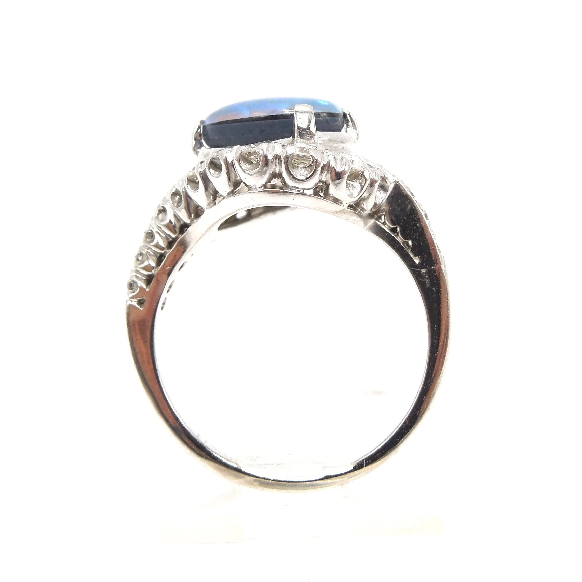 Oval Black Opal Surrounded by a Swirl of Diamonds in White Gold