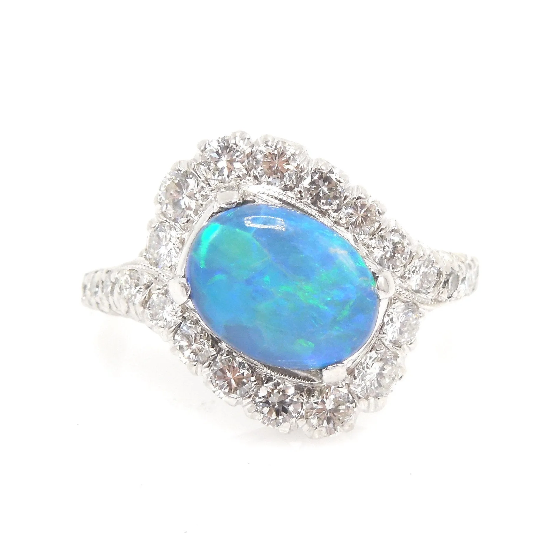 Oval Black Opal Surrounded by a Swirl of Diamonds in White Gold