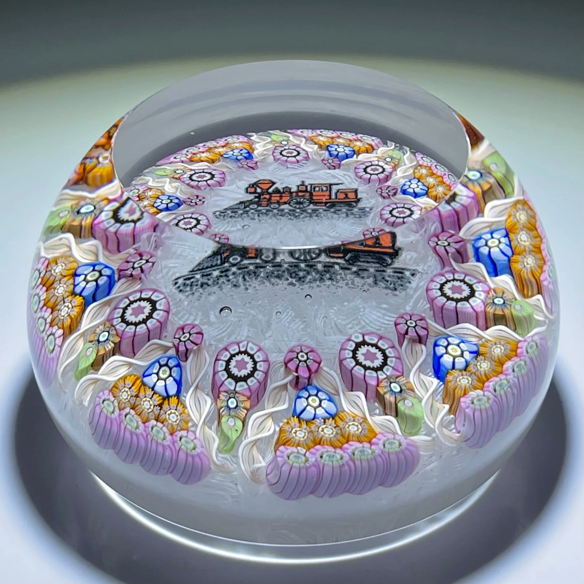 Perthshire Paperweights PP56 Patterned Complex Millefiori on Upset Muslin Cushion with a Train Decal